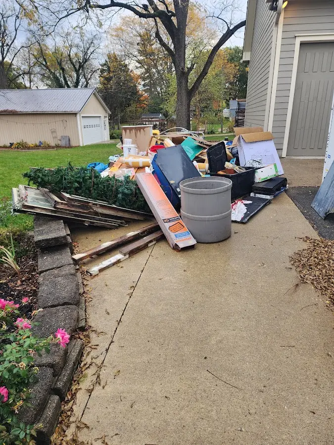 Dumpster being loaded with debris for 3 Yard Dumpster Rental in Hueytown